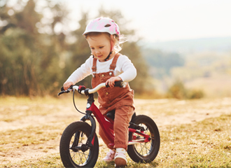 Child cycling around at conseb